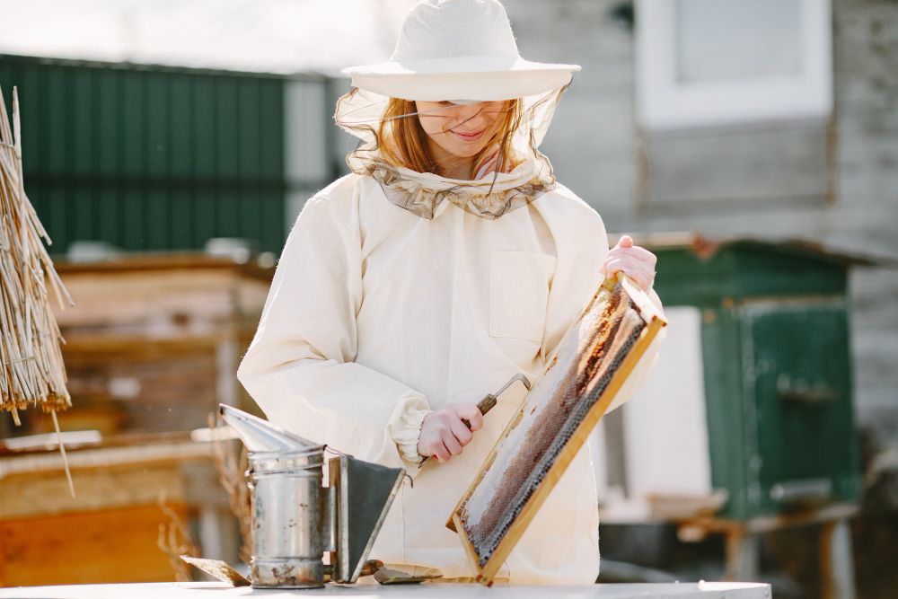 woman-beekeeper-looks-after-bees-wearing-coverall-woman-work-apiary